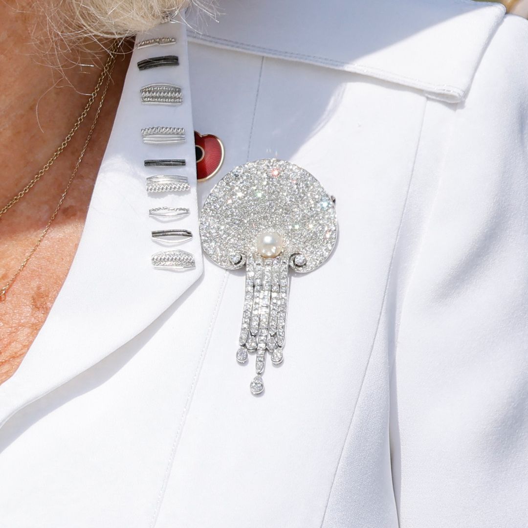 Queen Camilla wearing the late Queen's pearl and diamond brooch