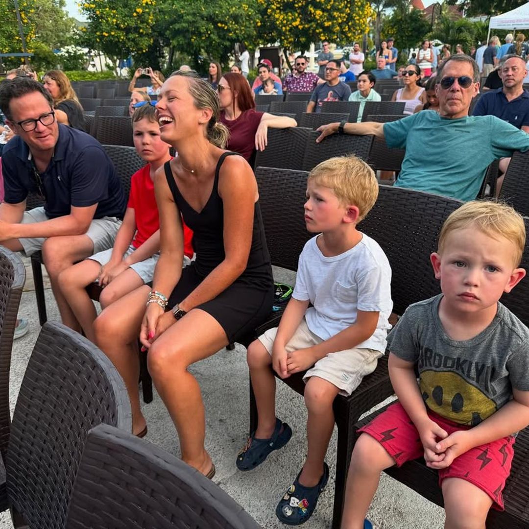 Dylan Dreyer captured mid-laugh while sitting in a crowd with Brian Fichera and their three kids, shared on Instagram