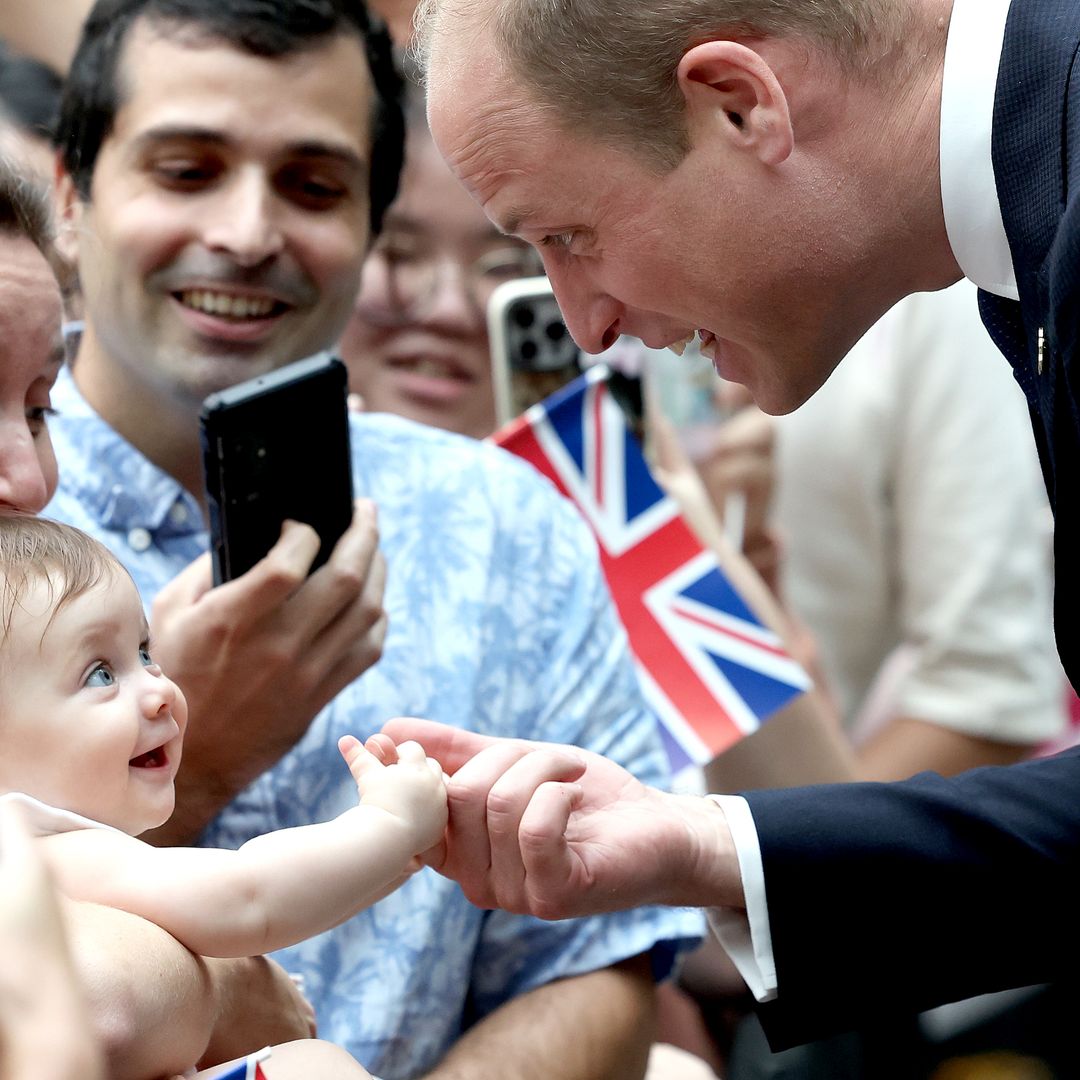 Watch Prince William's reaction as baby bites his finger during royal visit