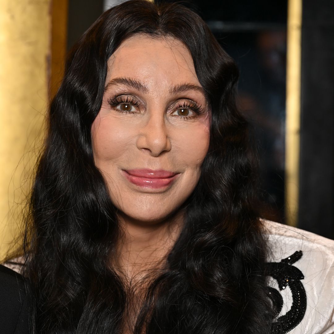Cher stuns in daring cut-out look with unexpected beehive hair alongside boyfriend Alexander Edwards