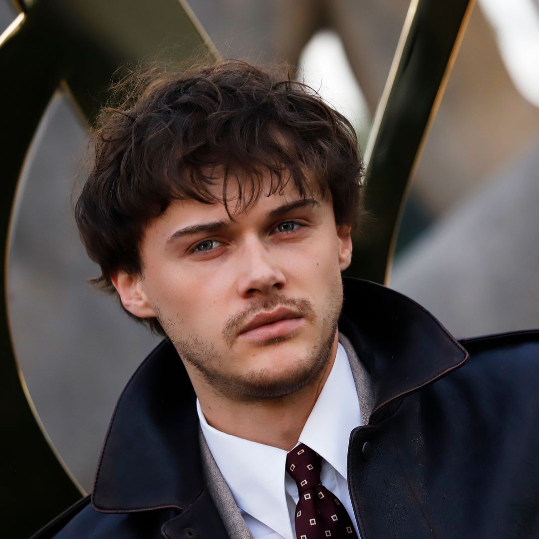 Christopher Briney just took style notes from Hailey Bieber in a baggy suit and leather jacket combo