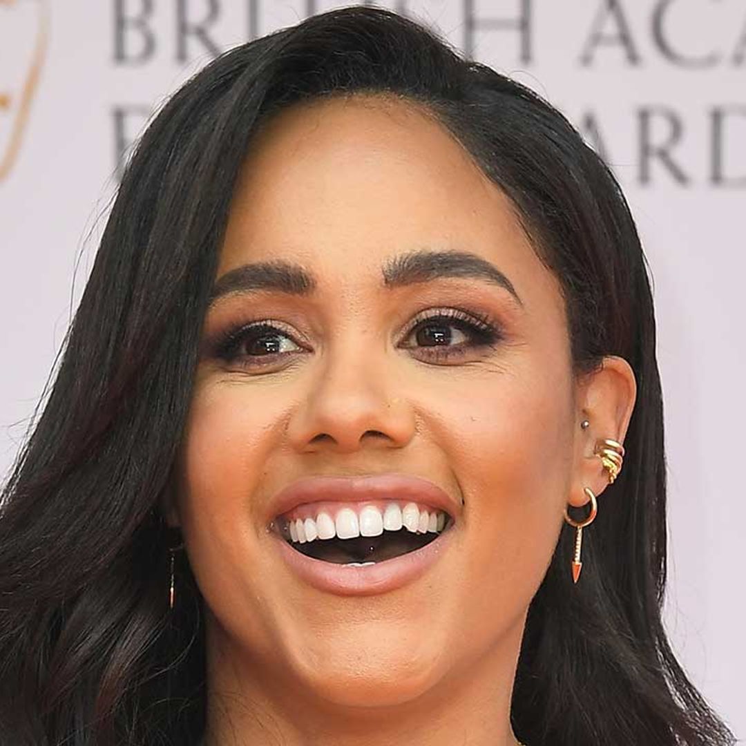 Alex Scott flashes toned abs in daring PVC corset and matching trousers