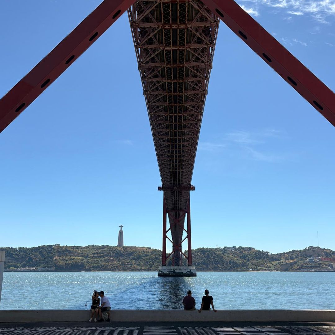 Lisbon's 25 de Abril bridge offers shade on a hot sunny day