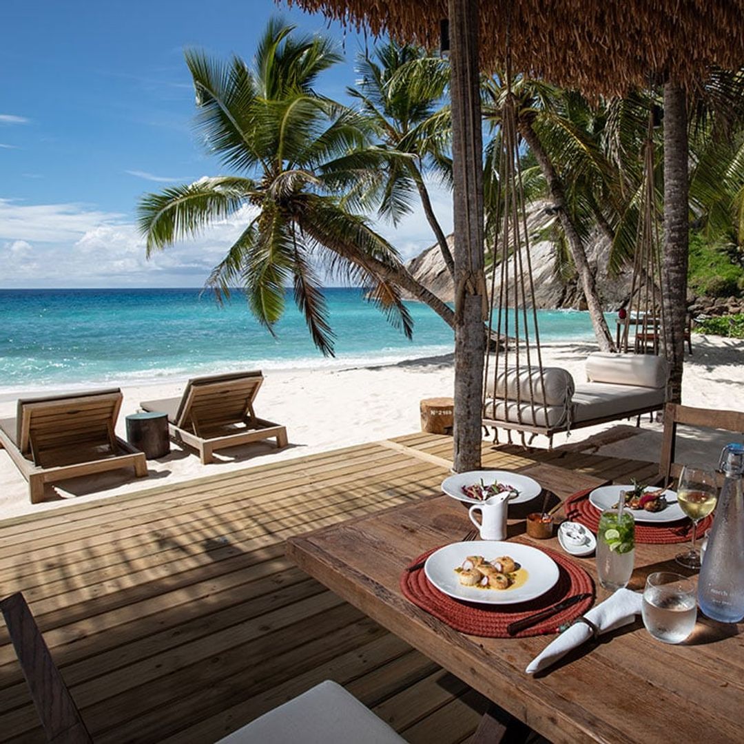 Beach bar with food laid out overlooking ocean in Seychelles
