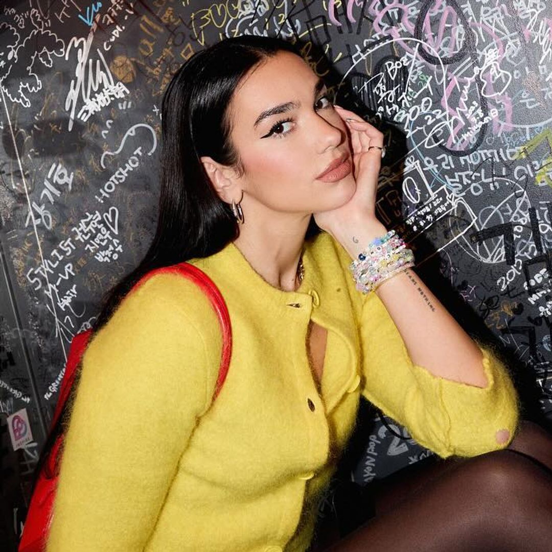 Dua Lipa's cheeky leather hotpants, sheer tights and lemon-yellow cardigan combo is a thing of dreams