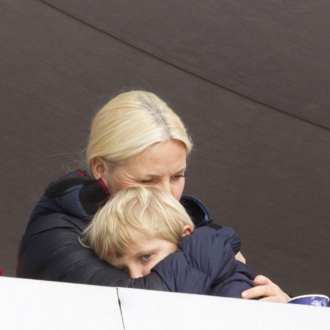 Princess Mette-Marit keeps her son warm at ski festival