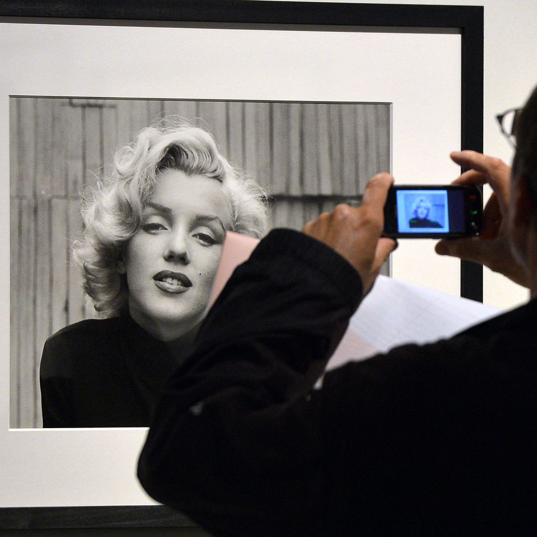 A visitor takes a snapshot of Alfred Eisenstaedt's Marilyn Monroe, Life magazine portrait