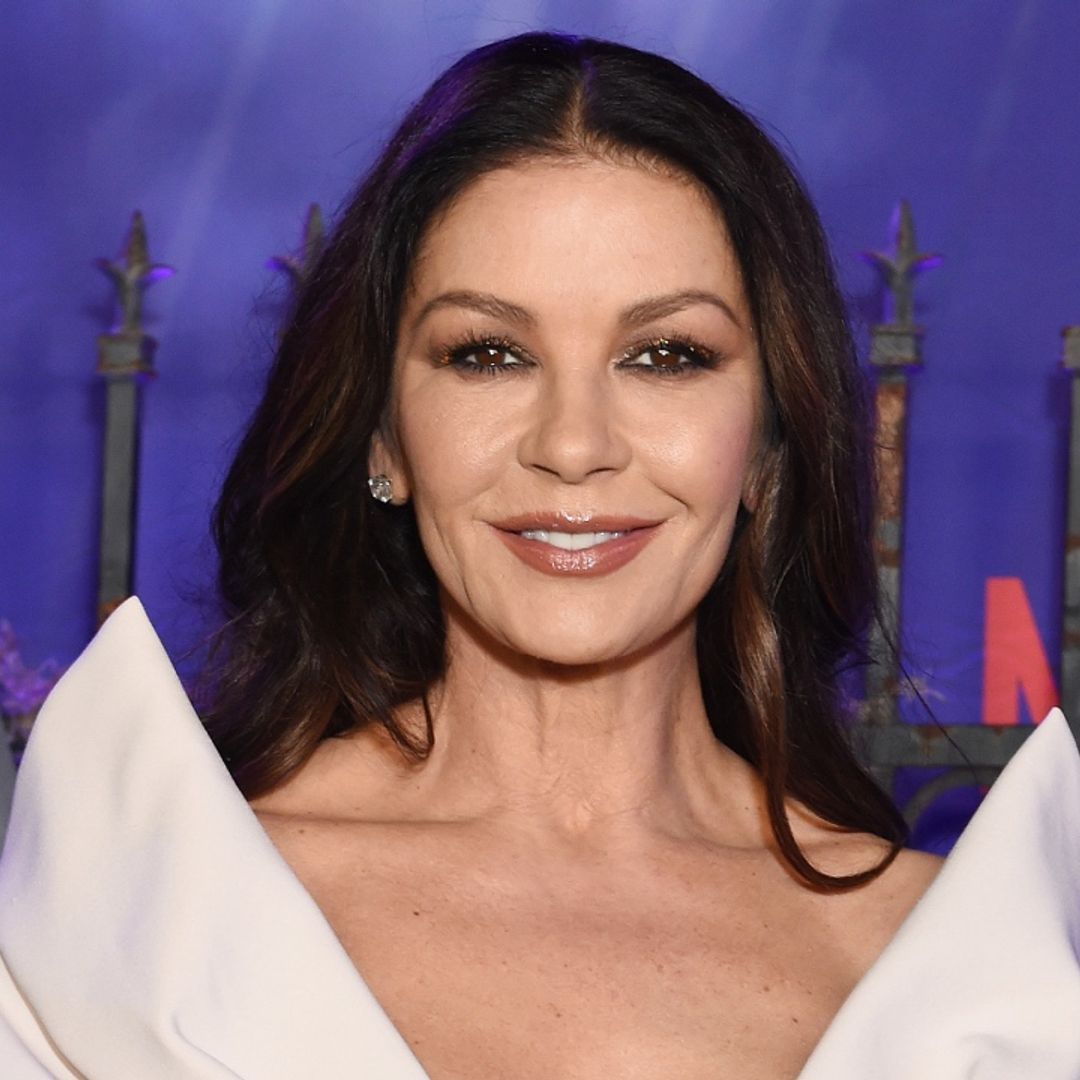 Catherine Zeta-Jones causes a stir in a lace and satin black dress