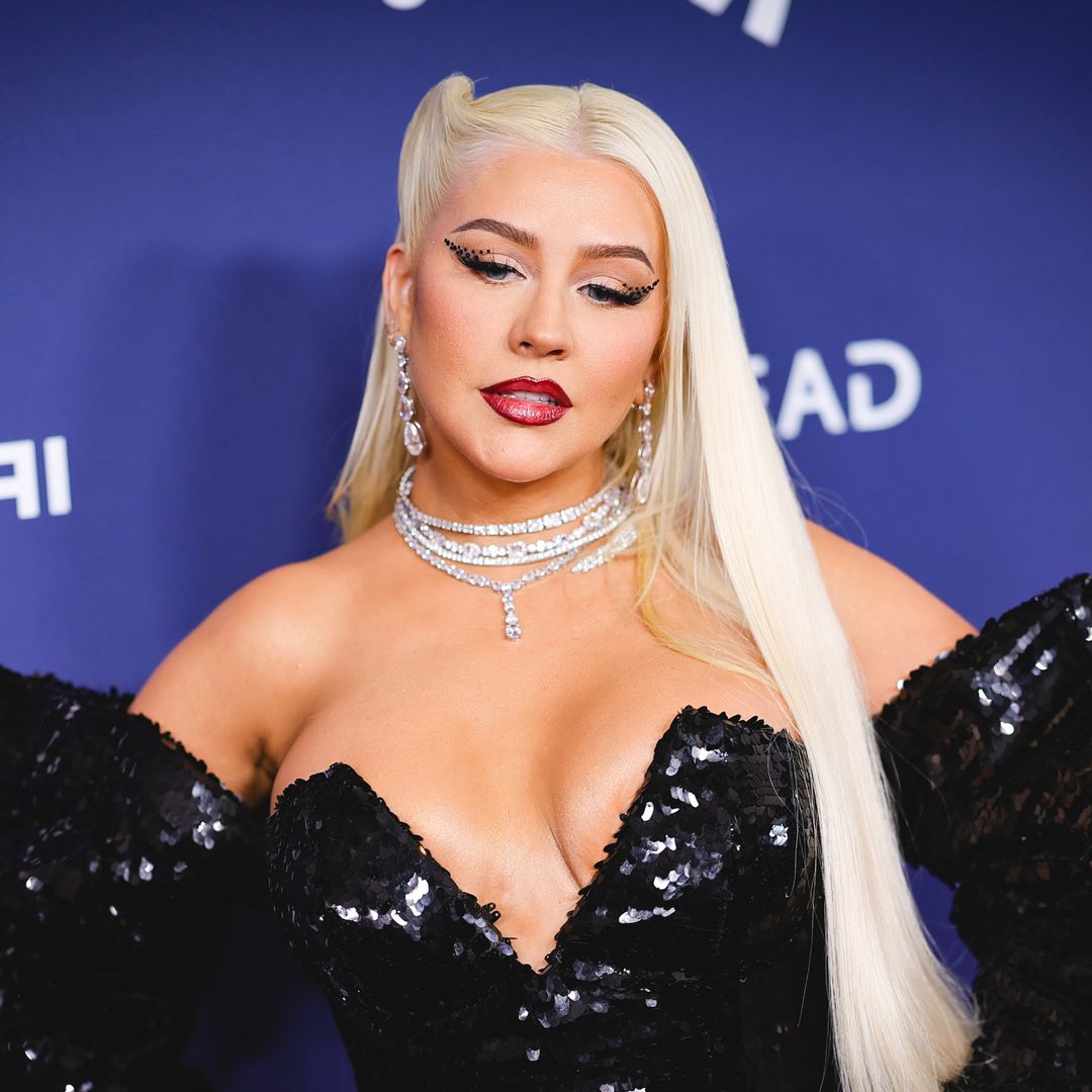 Christina Aguilera turns heads as she struts in semi-sheer skintight neon gown