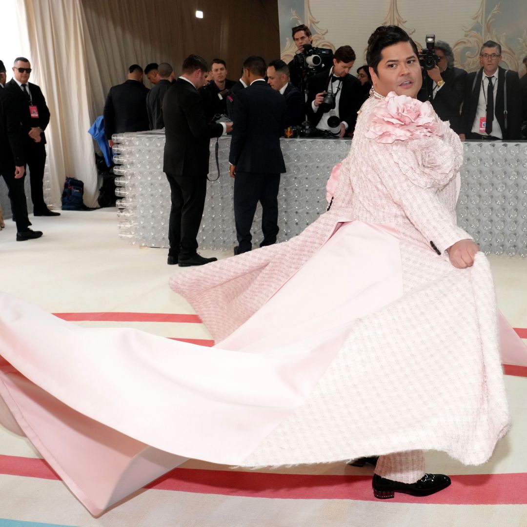 Harvey showing off his beautiful pink Met Gala gown by swishing it on the red carpet and turning around