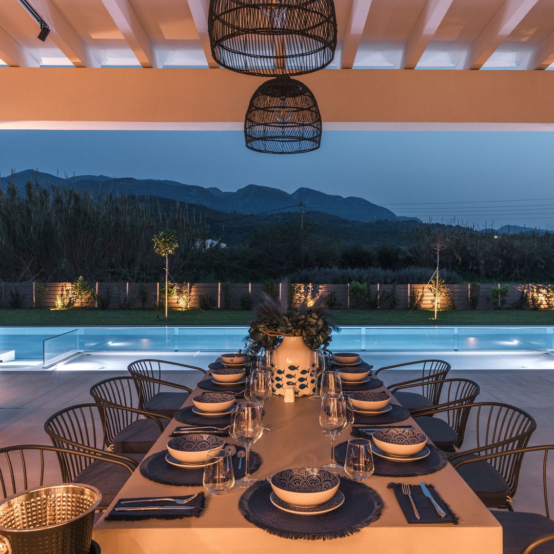 interior shot of dining area with pool in the background, luxury villa, mountain landscape 