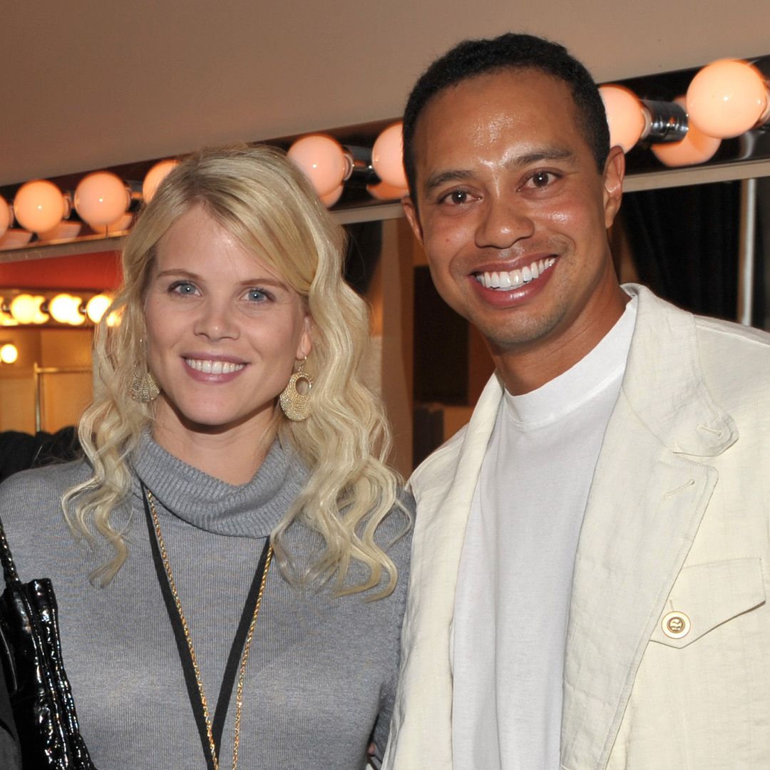 Tiger Woods and Elin Woods smiling for a photo at a party