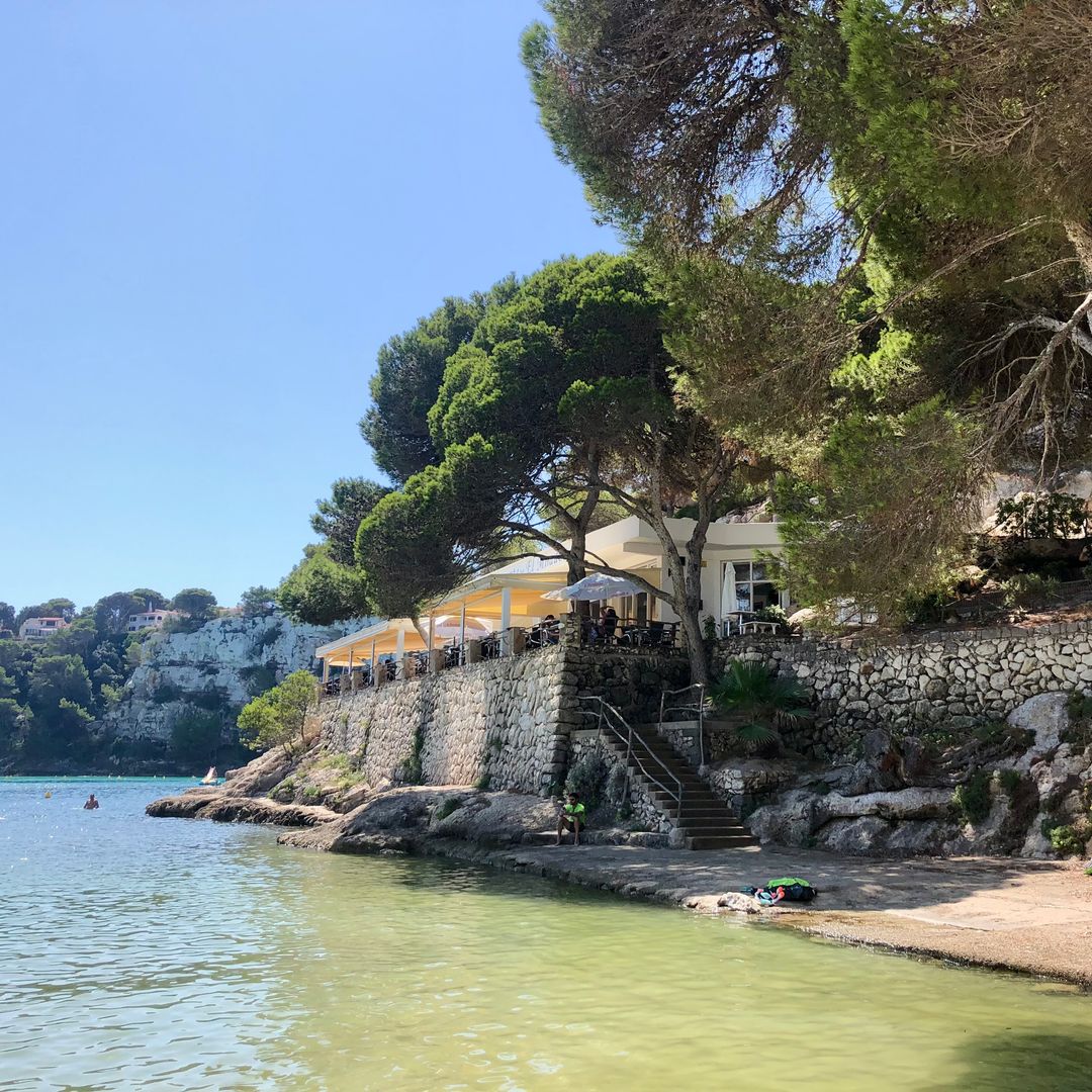 bar on the beach in Menorca surrounded by trees