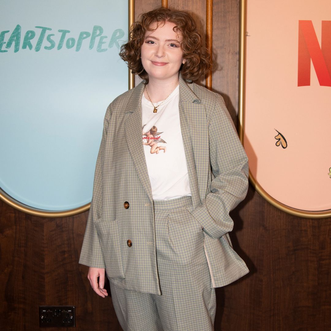 Heartstopper's creator Alice Oseman stood smiling at an exclusive Netflix event