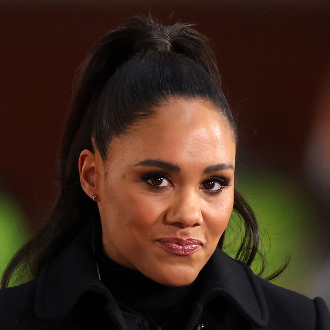 Alex Scott turns heads in leather boots and daring shirt dress