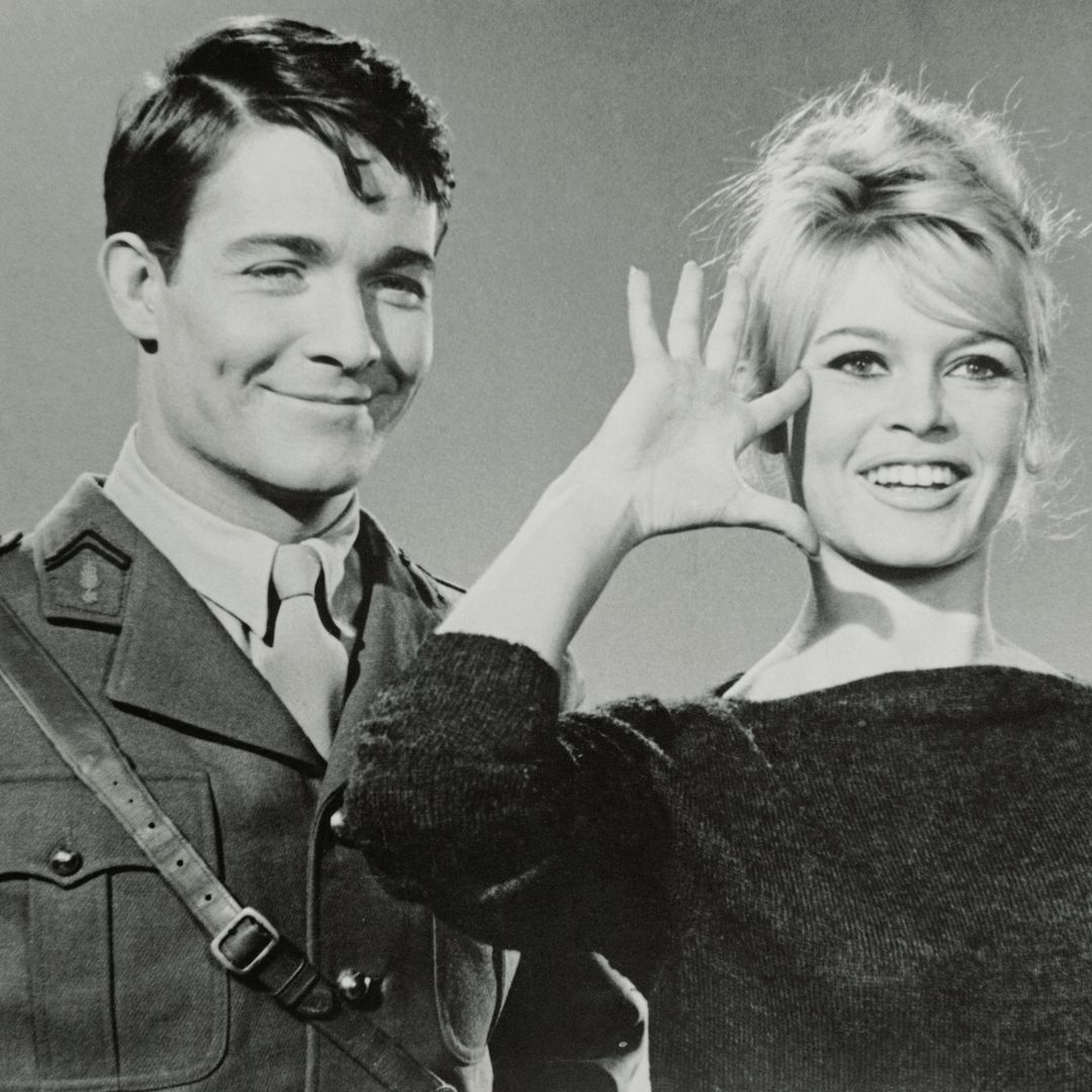 Slated to become a war heroine, on the screen that is, French movie actress Brigitte Bardot previews with a salute her role in the forthcoming film, Babette Goes to War. She will play a resistance fighter, with actor Jacques Charrier, left, portraying a dashing free French officer. Shooting is scheduled to start in January.