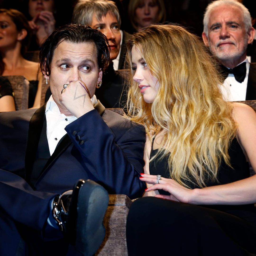 Johnny Depp and Amber Heard sat in cinema seats chatting