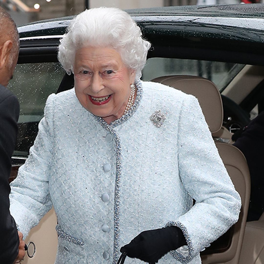 The Queen surprises in striking dress and gold handbag