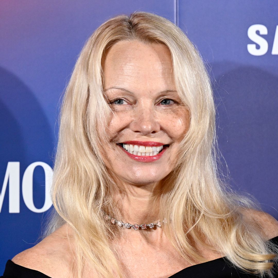 Pamela Anderson, 57, embraces natural beauty with nothing but berry-red lipstick