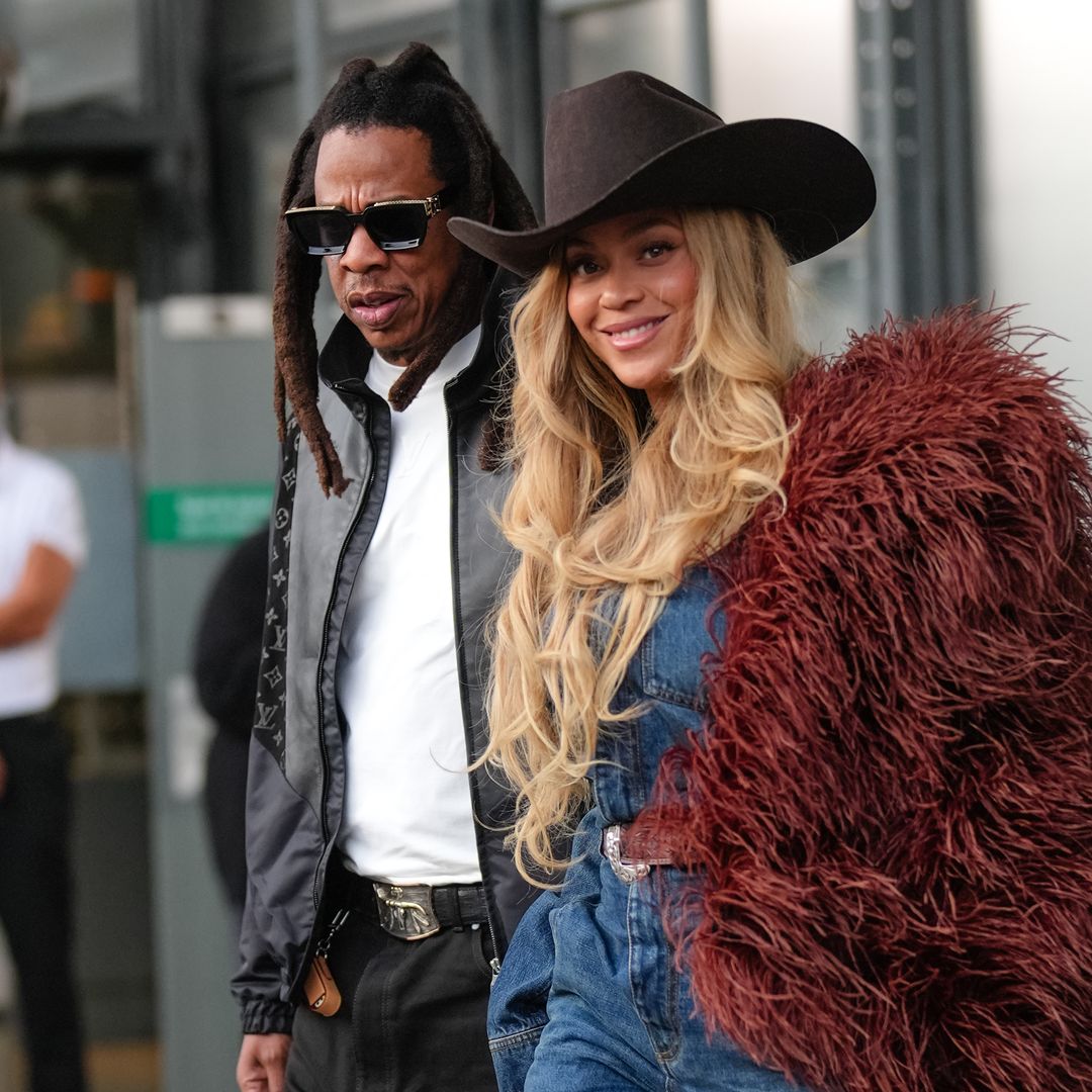 Jay-Z wears a black leather jacket with Louis Vuitton monogram logo print, a white t-shirt ; BeyoncÃ© Knowles / Beyonce wears a cowboy hat, a burgundy faux fur fluff coat on one shoulder, a blue denim shirt, during the Louis Vuitton Menswear Spring/Summer 2026 show as part of Paris Fashion Week on June 24, 2025 in Paris, France. (Photo by Edward Berthelot/Getty Images)