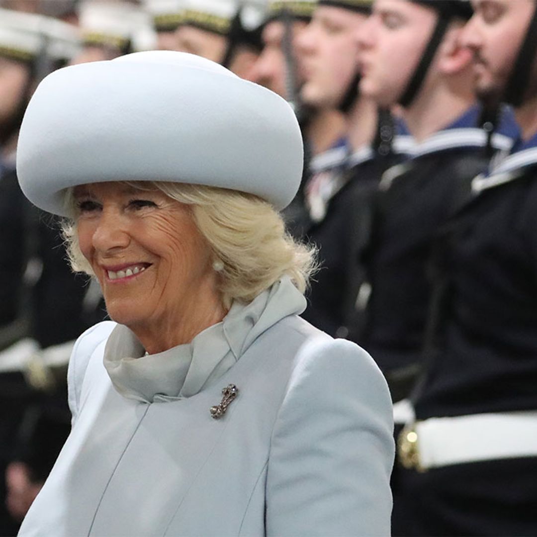 The Duchess of Cornwall is glam in an icy blue coat at the official Commissioning Ceremony