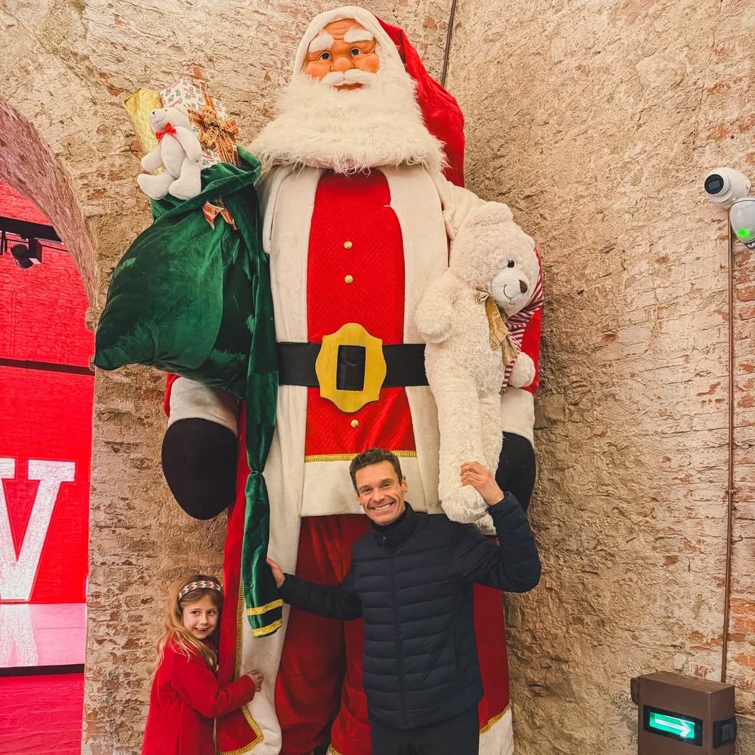 Ryan Seacrest and his niece Flora Leach pose for a photo with a giant Santa Claus figurine at a holiday display, shared on Instagram