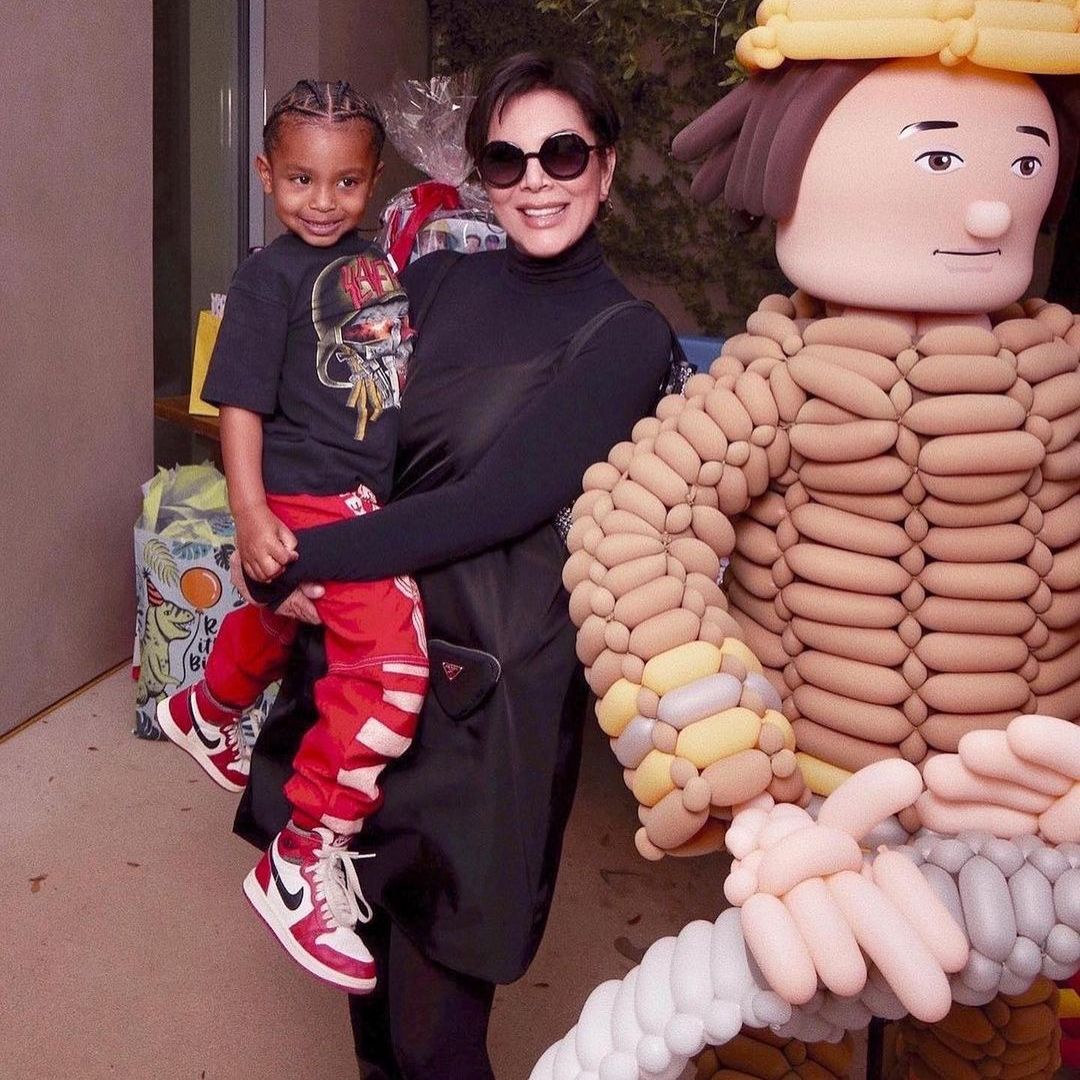 Psalm smiling with his grandmother Kris Jenner
