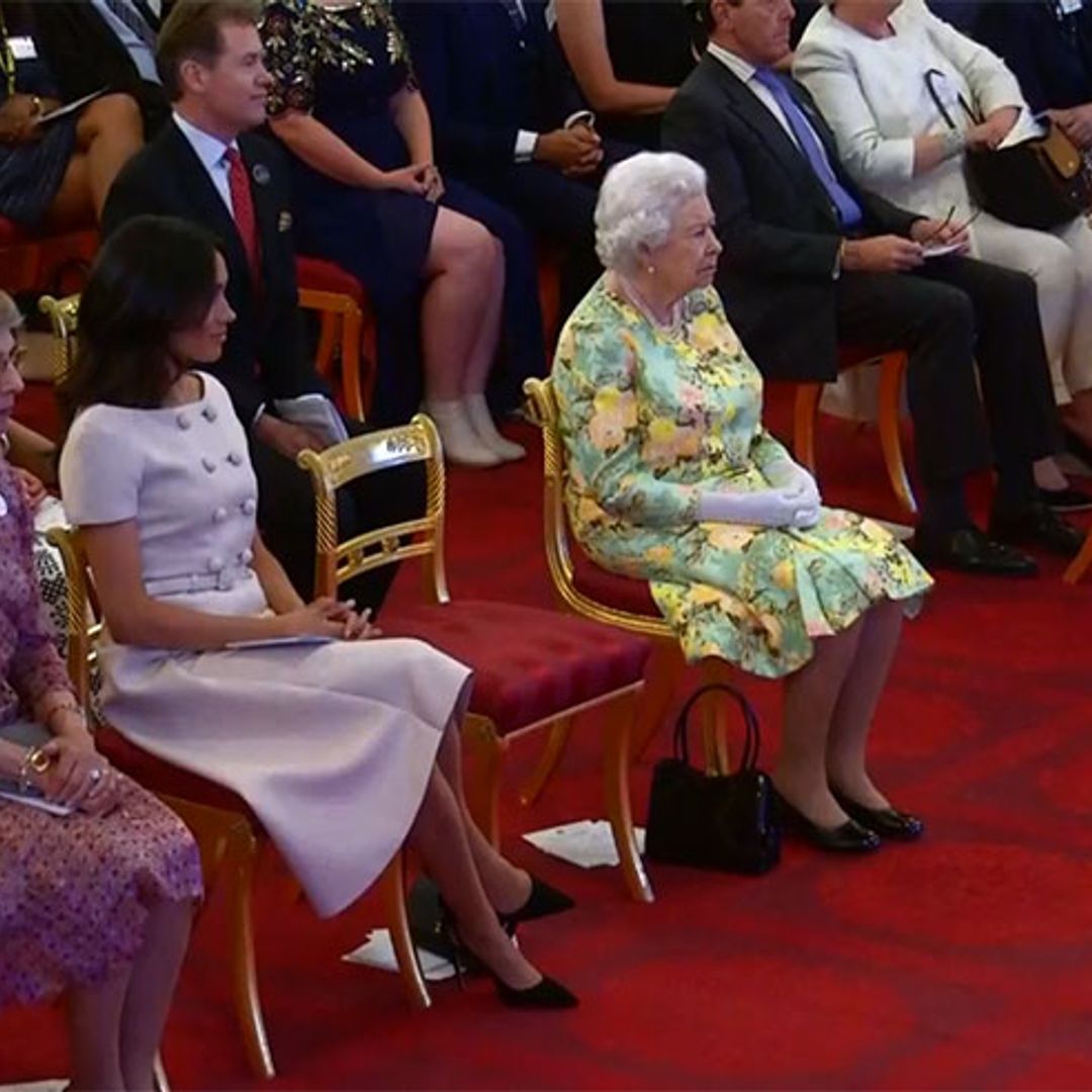 Meghan Markle looks elegant in Prada while hosting awards ceremony alongside the Queen