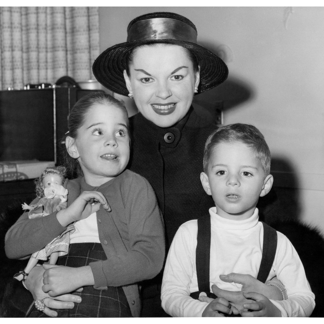 Actress Judy Garland (1922-1969) holds her children Lorna Luft and Joey Luft aboard a ship on a trip to Europe in a candid shot taken in 1957, United States