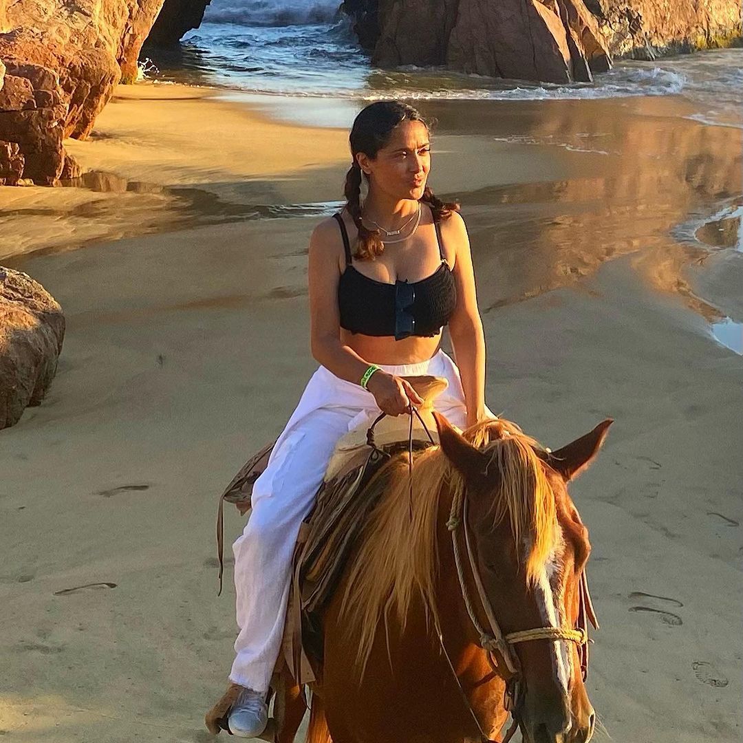 Salma Hayek showcases her sensational figure in bra top as she rides horseback during dreamy Mexican vacay