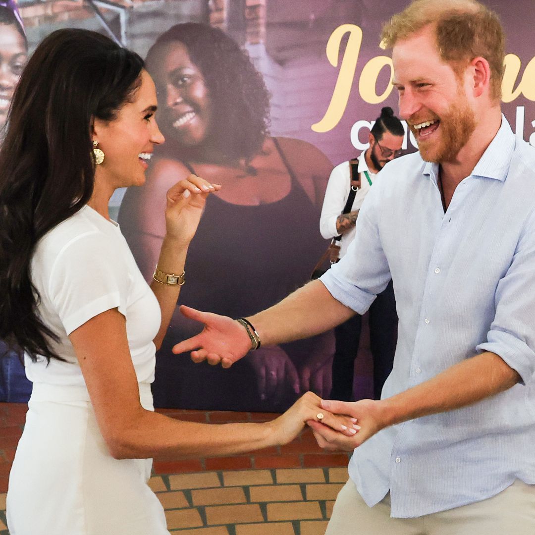 Prince Harry and Meghan Markle look madly in love as they recreate iconic wedding photo