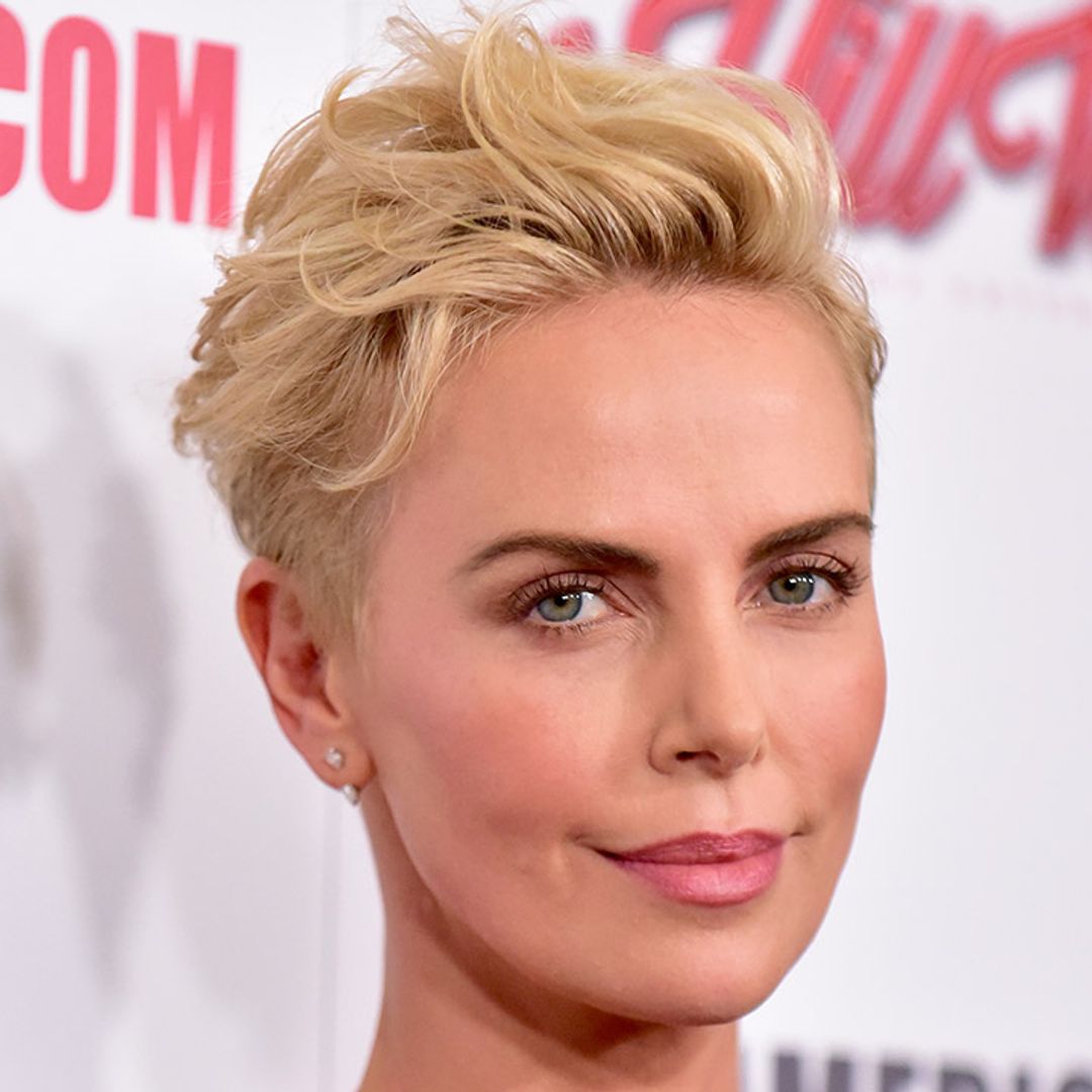 Where does Charlize Theron live with her adopted daughters?