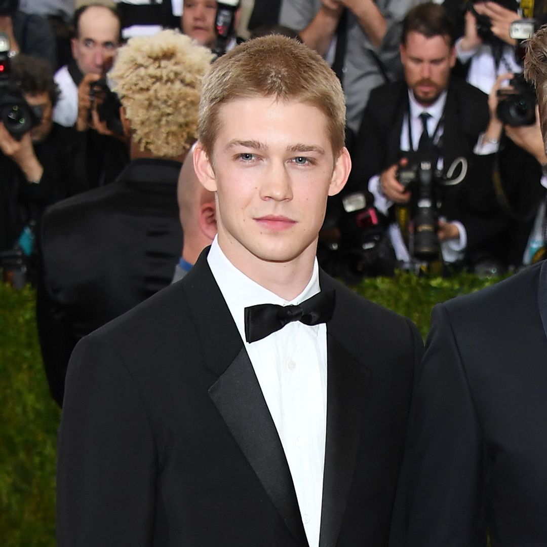 Joe Alwyn with a buzzcut, wearing a suit on the red carpet at the Met Gala