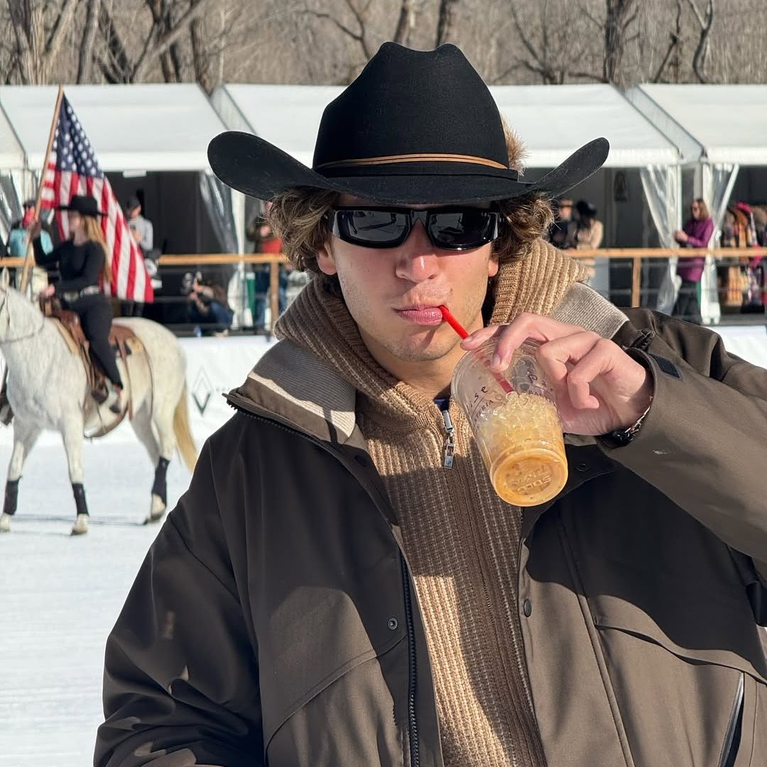 Cosuin Colton in cowboy hat with coffee