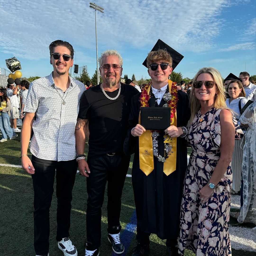 Guy Fieri poses with son Hunter (left), son Ryder (second right) and wife Lori