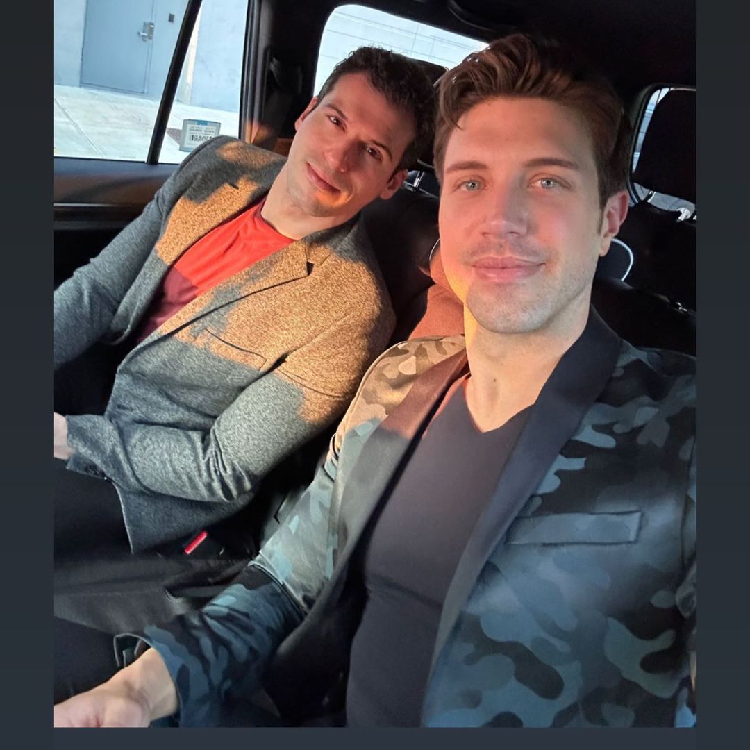 Tommy and Gio smiling taking a selfie while sat in a car