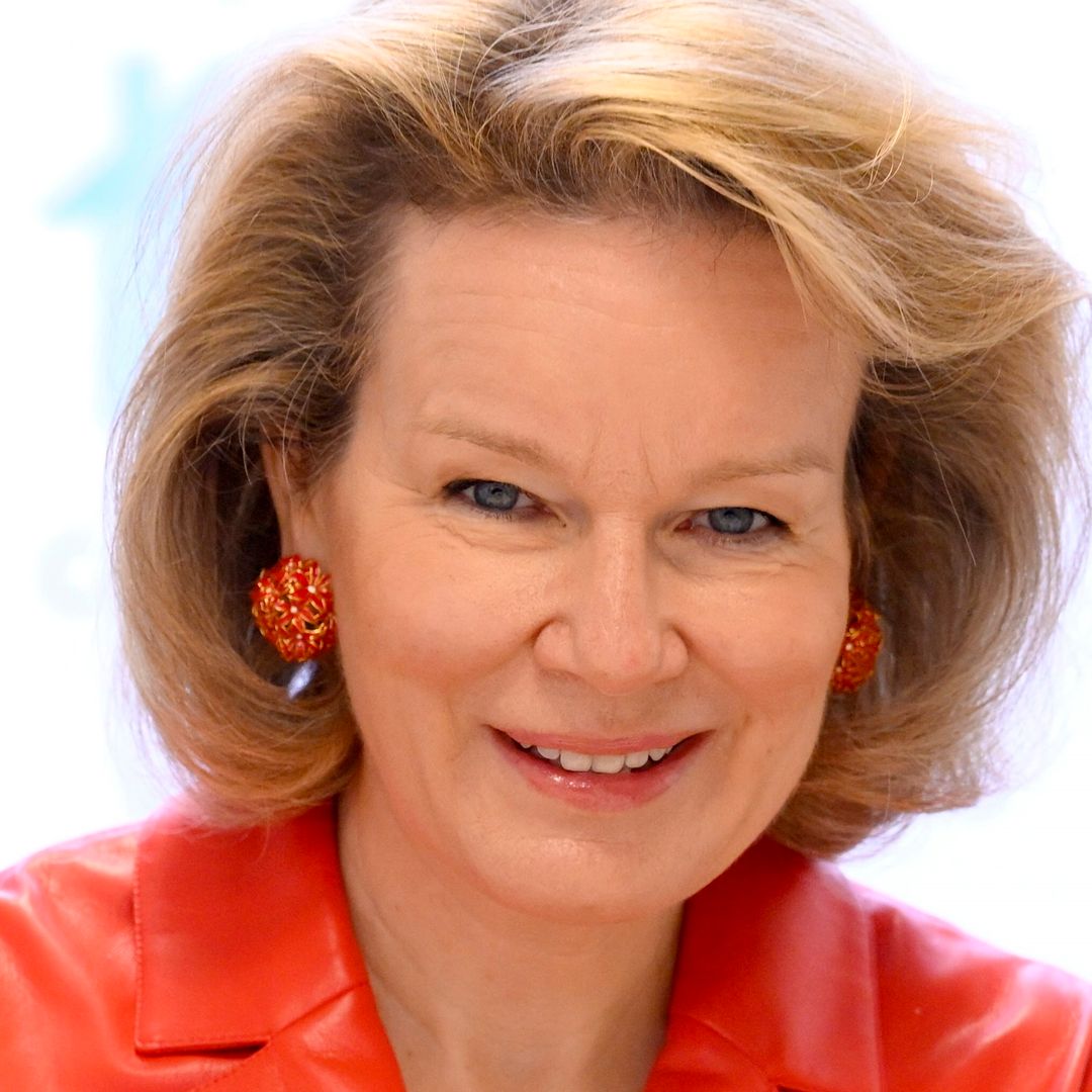 Queen Mathilde surprises in waist-cinching red leather jacket for sensitive solo outing