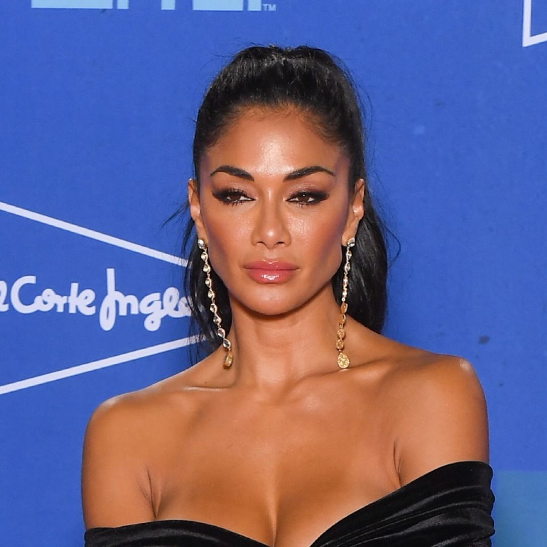 Nicole Scherzinger takes the plunge in a white swimsuit – watch video