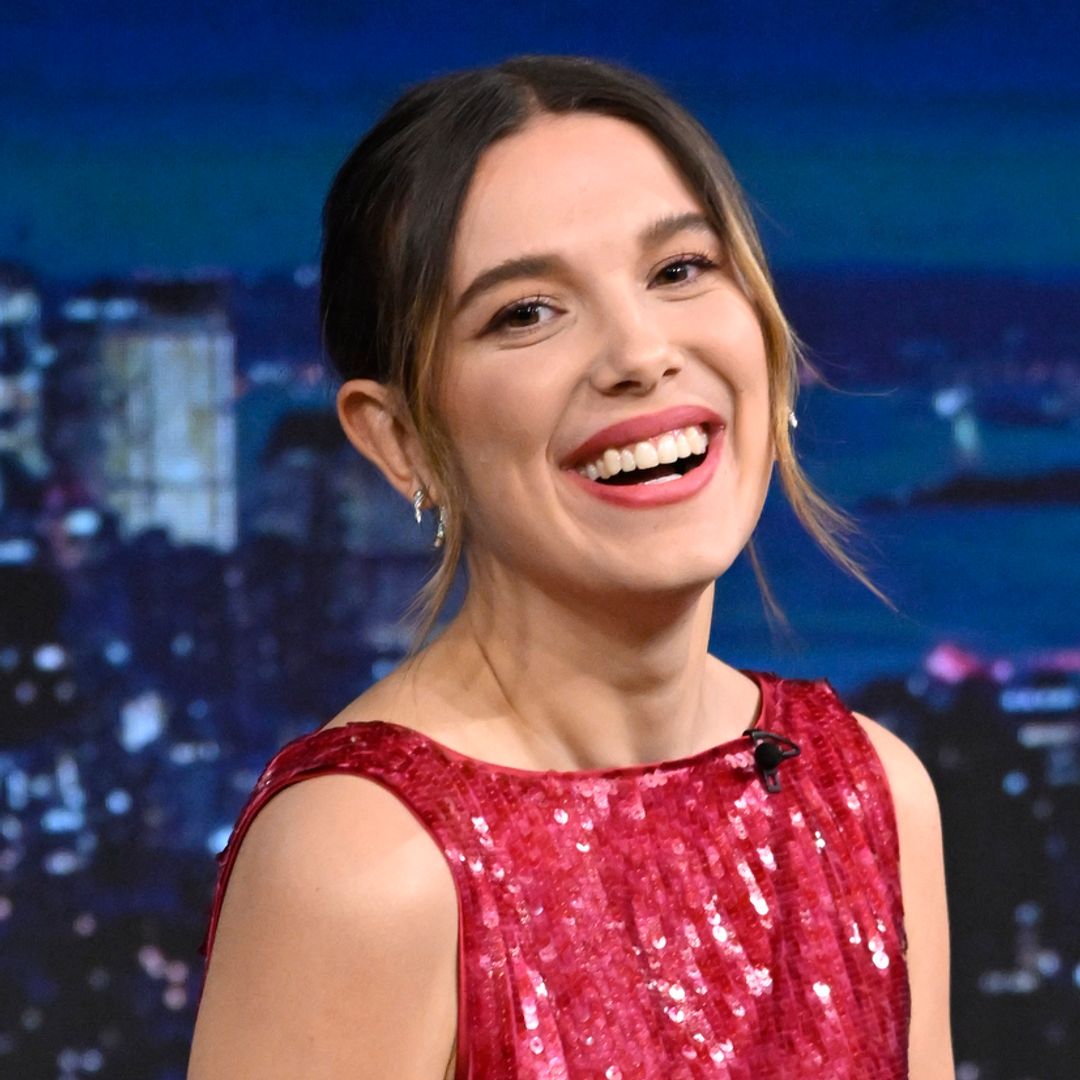 Millie Bobby Brown puts a festive spin on the ‘underwear as outerwear’ trend in sheer tights, boxers and fluffy earmuffs