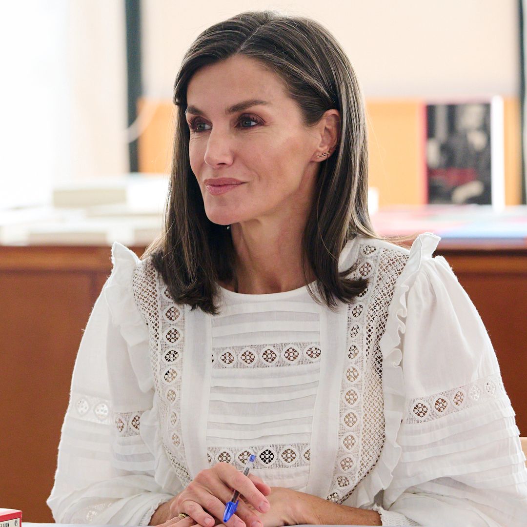 Queen Letizia is pristine in bridal white skinny trousers and floatiest blouse