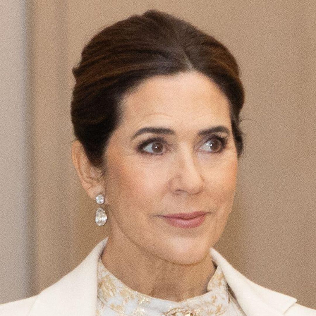 Queen Mary channels Snow Queen in cinched gold gown