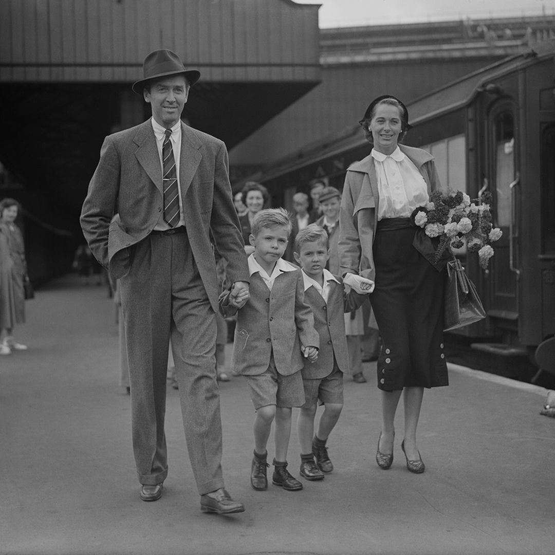 American actor James Stewart (1908 - 1997) arrives at Waterloo Station in London with his wife, actress and model Gloria Hatrick McLean (1918 - 1994) and her sons Ronald (left) and Michael, 28th August 1950. They arrived on the 'Queen Elizabeth' boat train.