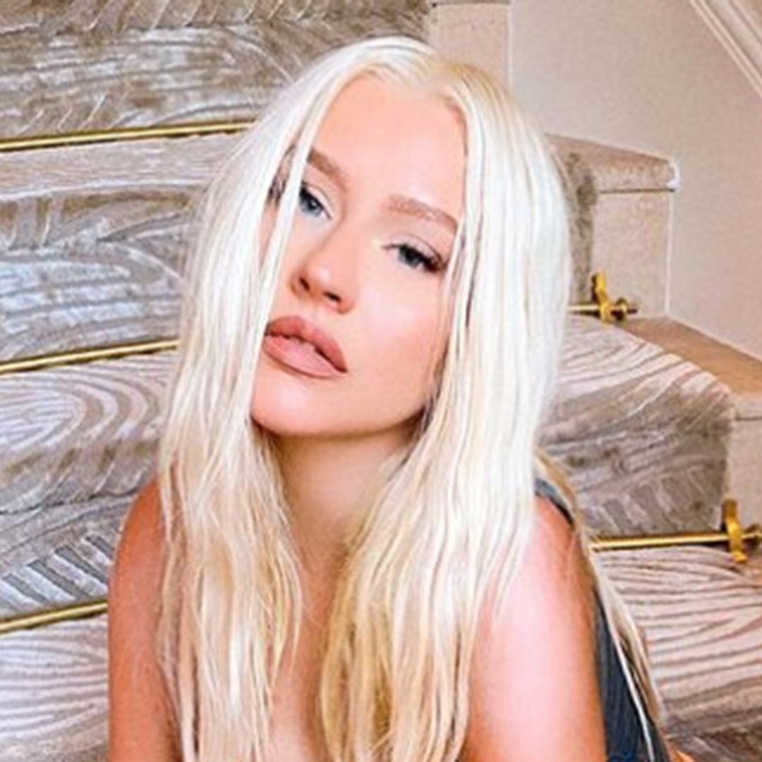 Christina Aguilera causes a stir posing topless in tiny briefs