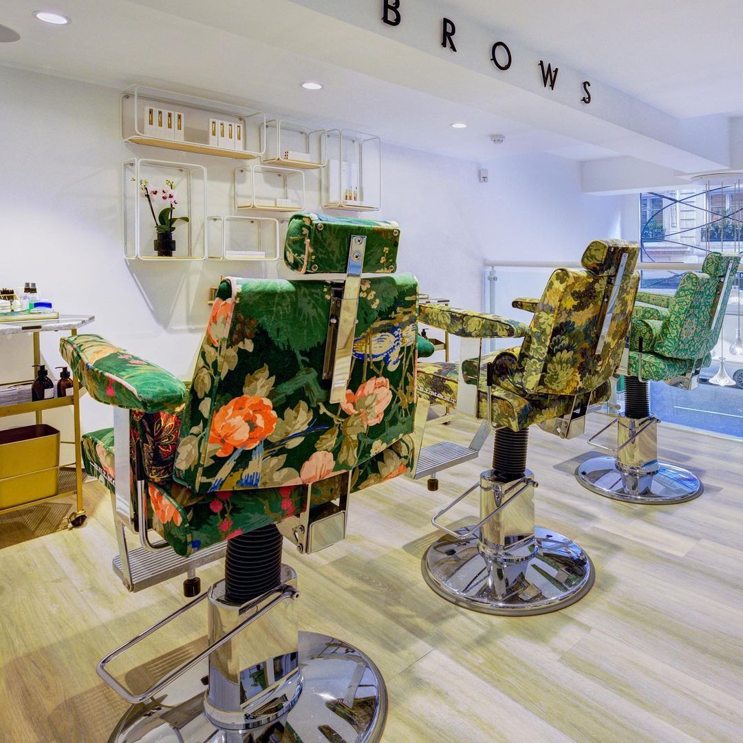 Green chairs inside Nails & Brows salon