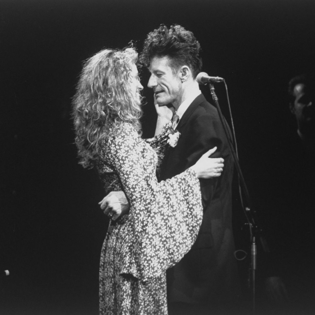 Actress Julia Roberts and her her husband, c/w singer Lyle Lovett embracing during his concert which took place the night of their wedding day.