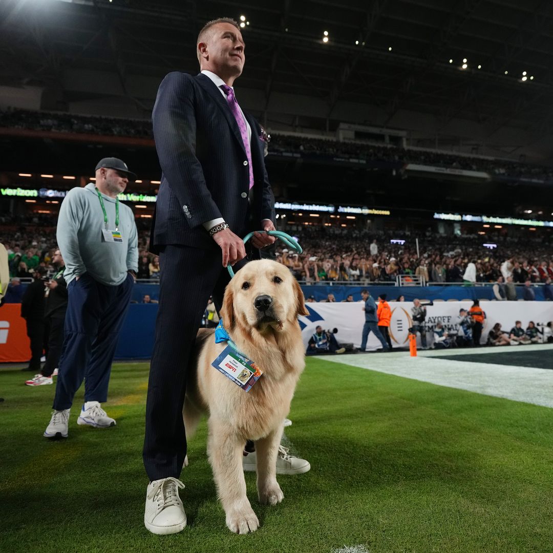 ESPN broadcaster Kirk Herbstreit stands with his dog Peter Herbstreit during the second half of the Orange Bowl at Hard Rock Stadium on January 9, 2025 in Miami Gardens, Florida.