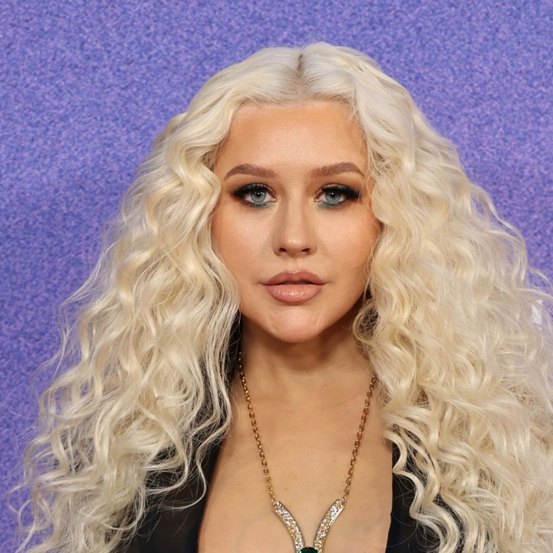 Christina Aguilera is an absolute bombshell in purple leather dress