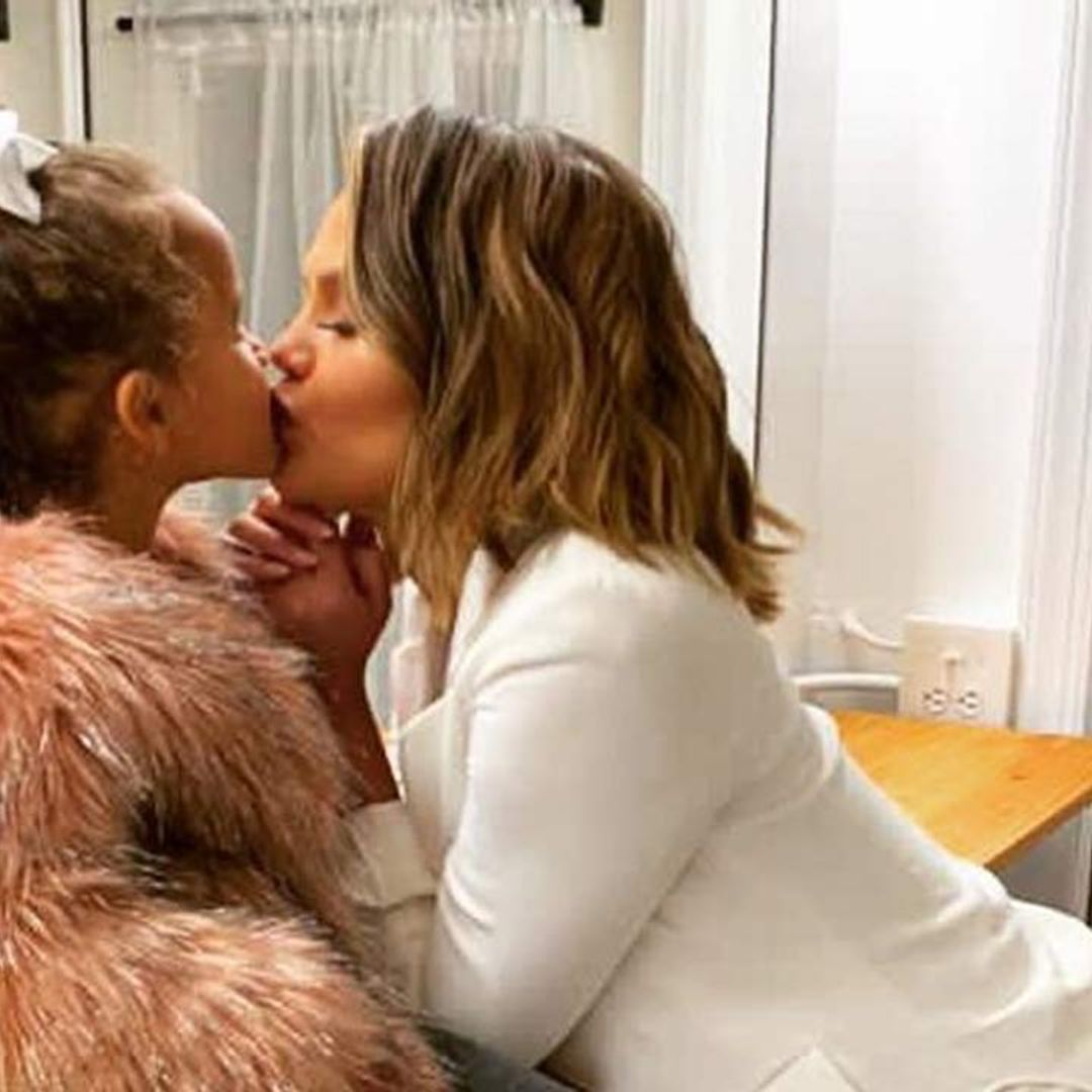 Chrissy Teigen and daughter Luna twin in fierce jeans and boots combo