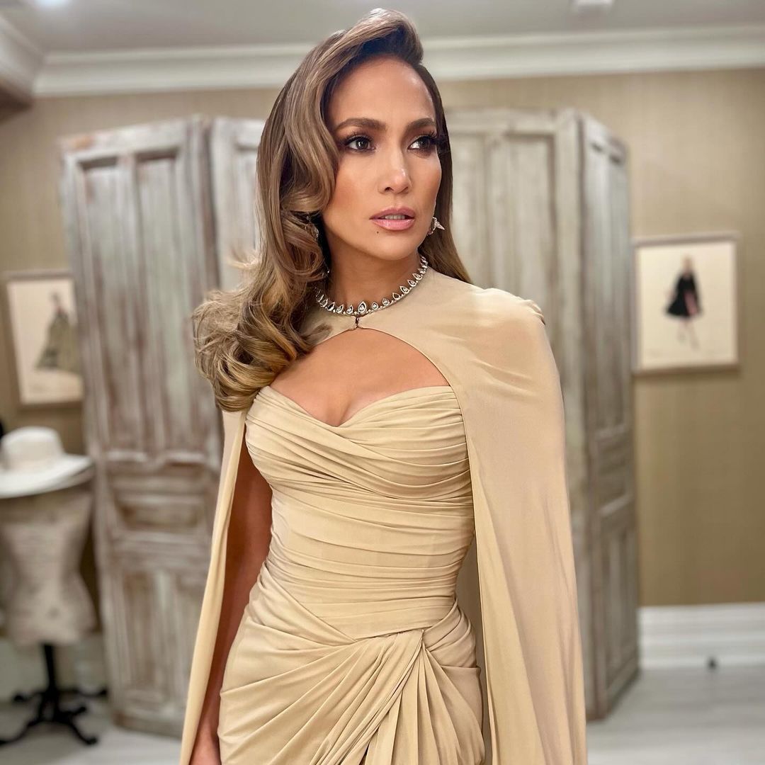 Jennifer Lopez stuns in a thigh-high slitted beige gown and cape look to accept the 'Pride' award