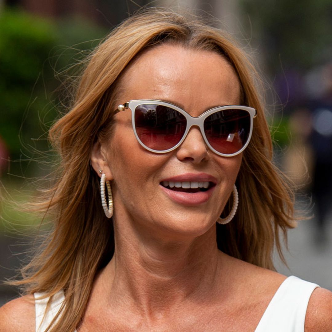Amanda Holden poses in all-white for candid hotel room snap
